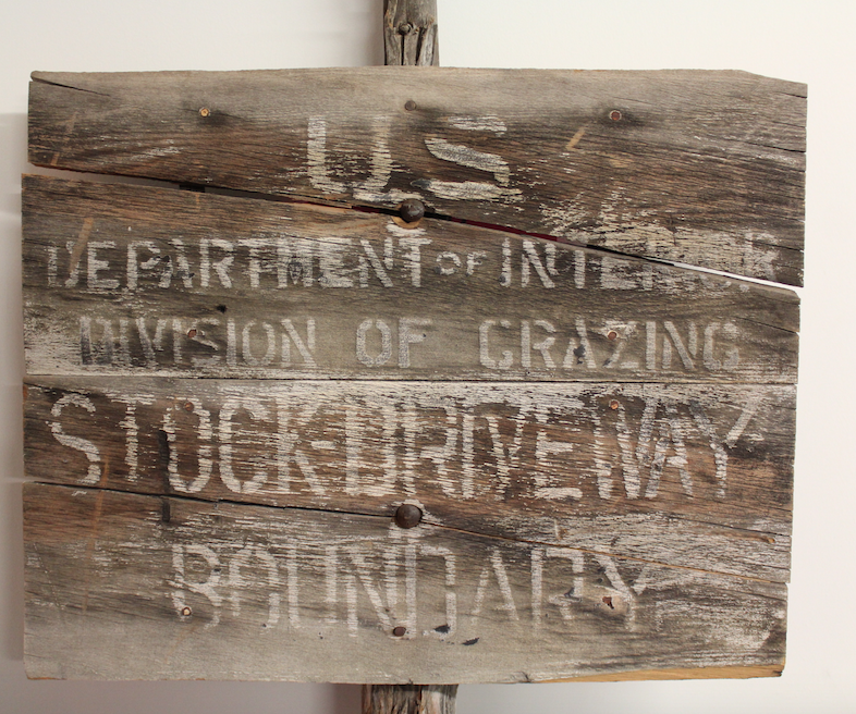 A Division Of Grazing Service sign made of milled lumber on a juniper post. The Division Of Grazing was renamed then merged with the General Land Office to form the BLM in 1946.